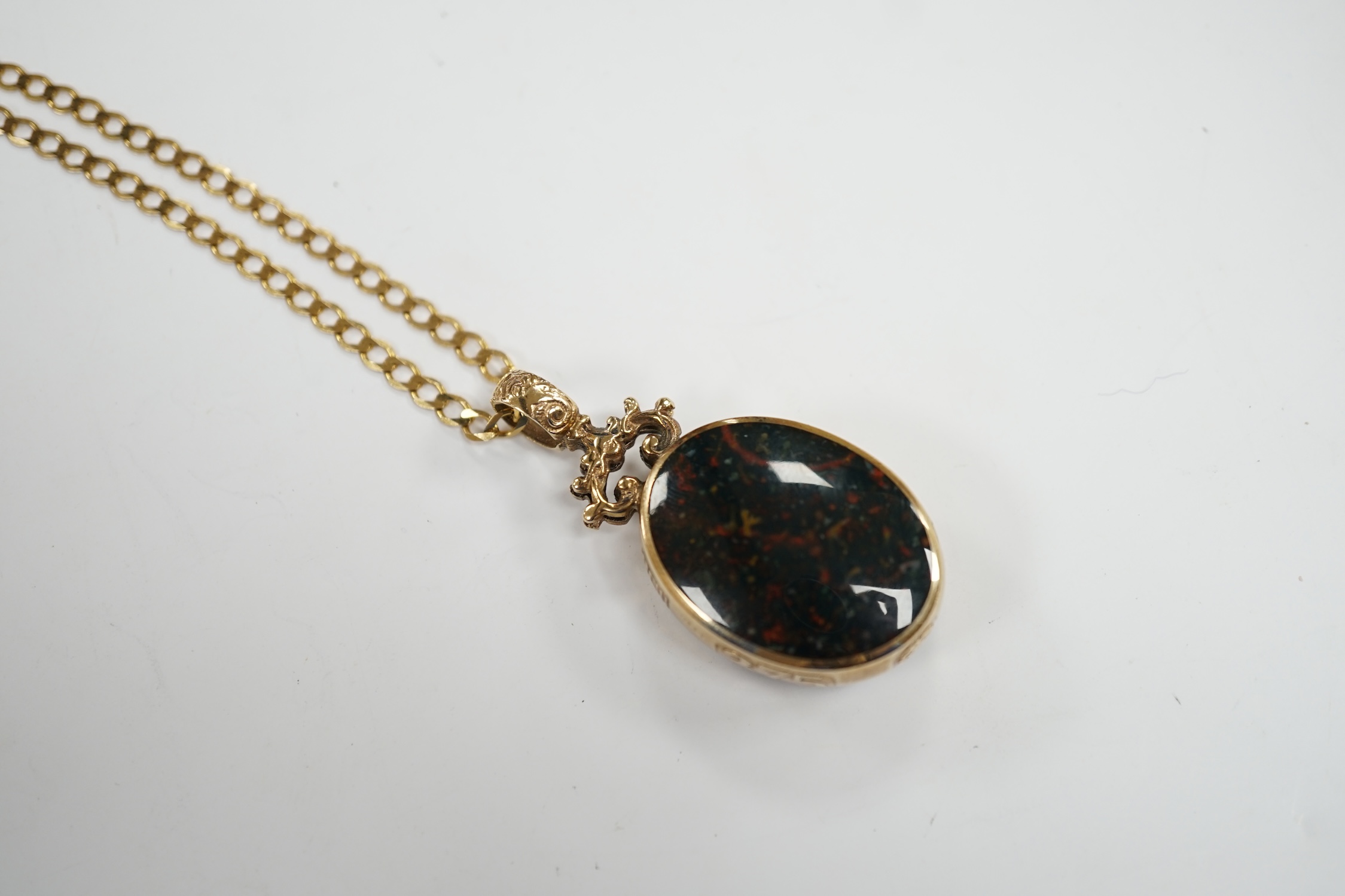 A modern 9ct gold mounted carnelian and bloodstone set oval 'Millennium' pendant, by Davis Scott Walker, overall 49mm, on a 9ct gold curb link chain, 50cm, gross weight 22.9 grams. Fair condition.
